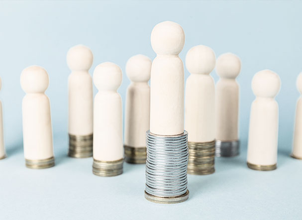 Beige pins with a rounded top edge, positioned above stacks of silver and gold coins