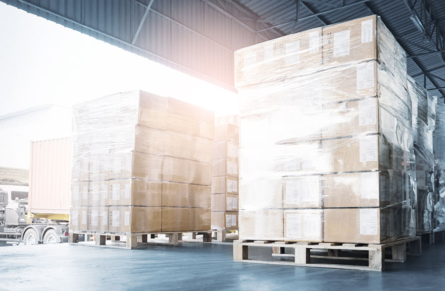 Photograph of a cargo port, with several brown, stacked boxes